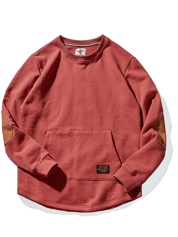 Solid color round neck sweatshirt with kangaroo pocket and elbow patches in red. Warm, casual fit for everyday comfort and style.